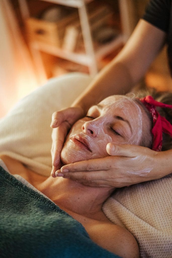 Woman receiving a relaxing facial treatment in a spa retreat