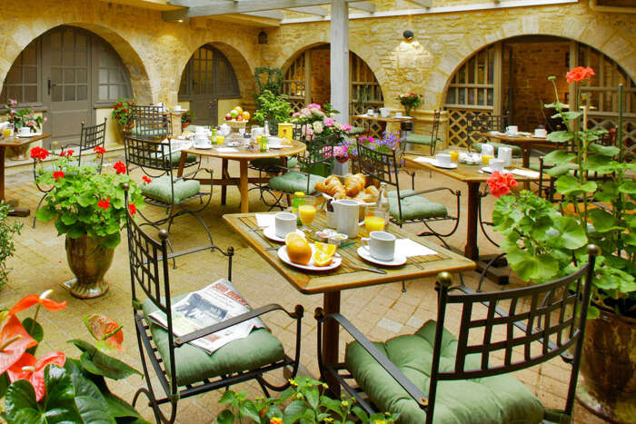 Historic courtyard at Hôtel des Récollets in Sarlat, offering budget-friendly accommodations.