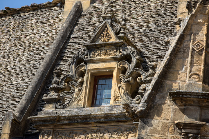 Ornate stonework dormer window of the historic Maison de La Boétie in Sarlat-la-Canéda.