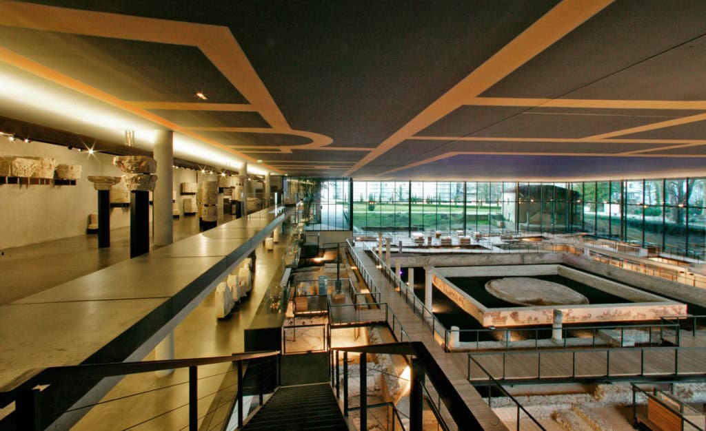 Interior view of the Vesunna Gallo-Roman Museum in Périgueux, France, showcasing Roman ruins integrated with modern architecture.